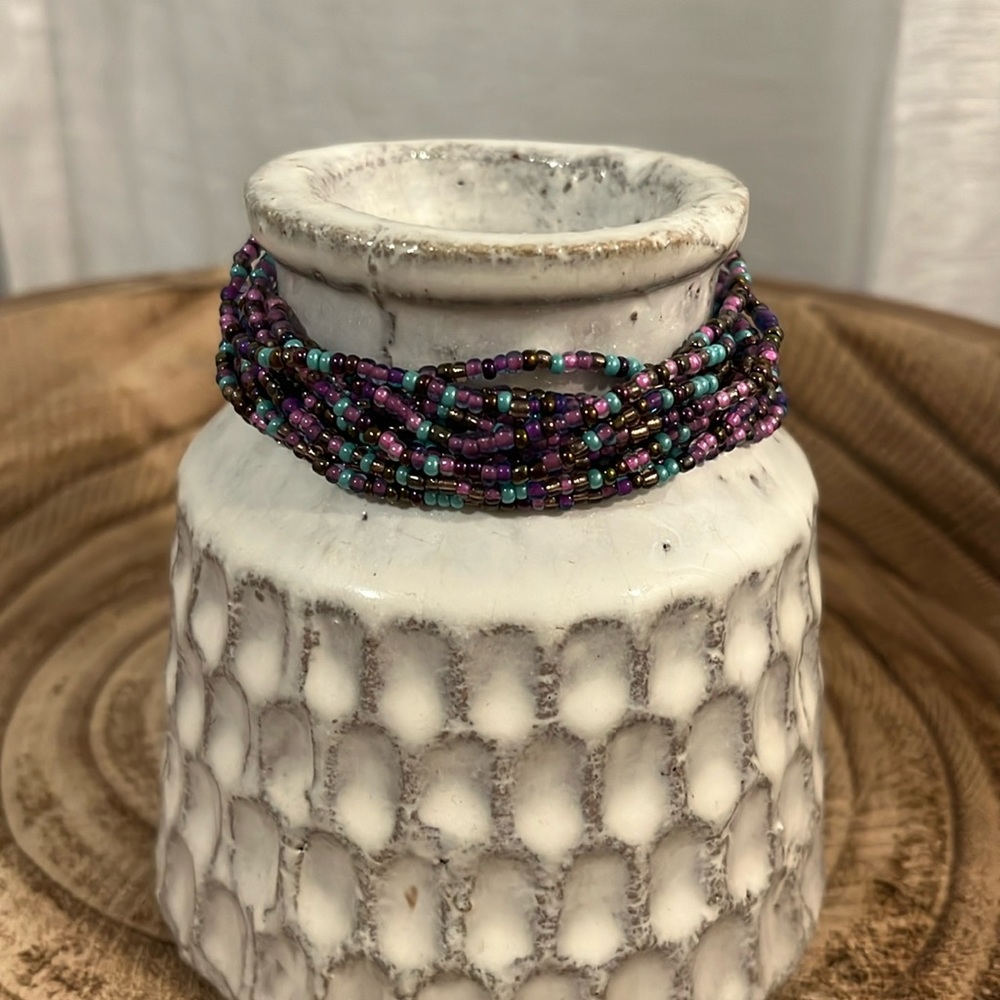 Multi shaded purples and lavender seed beads with turquoise accents.